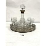 A SILVER COLLARED CUT GLASS SHIPS DECANTER AND SIX CUT GLASS SHERRY GLASSES WITH A CIRCULAR PLATED