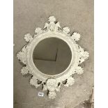 A PAINTED ORNATE METAL WALL MIRROR WITH FLORAL DECORATION MIRROR PLATE, 30CMS DIAMETER