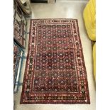 A RED GROUND WOLLEN IRAN RUG 220 X 140 CMS