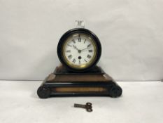 A LATE VICTORIAN EBONISED AND MAHOGANY MANTLE CLOCK