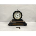 A LATE VICTORIAN EBONISED AND MAHOGANY MANTLE CLOCK