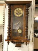A LATE VICTORIAN MAHOGANY VIENNA WALL CLOCK WITH TURNED SIDE SUPPORTS