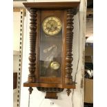 A LATE VICTORIAN MAHOGANY VIENNA WALL CLOCK WITH TURNED SIDE SUPPORTS