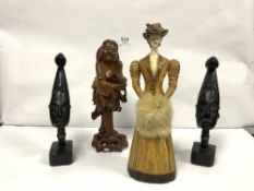 A CARVED ORIENTAL FIGURE OF A FISHERMAN, 30CMS, A PAIR OF TRIBAL BUSTS, AND A LADY HOLDING A MUFF