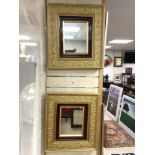 A PAIR OF GILT FRAMED WALL MIRRORS WITH MAHOGANY INSET AND ART NOUVEAU EMBOSSED PATTERN 48 X 52 CMS