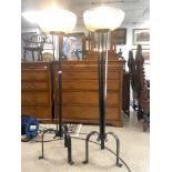 A PAIR OF WROUGHT IRON UPLIGHTERS WITH CIRCULAR ETCHED GLASS SHADES W/O 140 CMS HIGH , GLASS