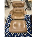 A CHARLES EAMES STYLE BROWN LEATHER AND ROSEWOOD FINISH EASY CHAIR AND MATCHING STOOL
