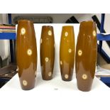 FOUR MATCHING TALL BROWN OPAQUE GLASS SHADES, 48CMS