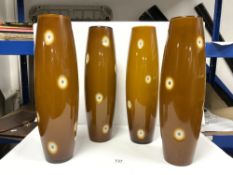 FOUR MATCHING TALL BROWN OPAQUE GLASS SHADES, 48CMS