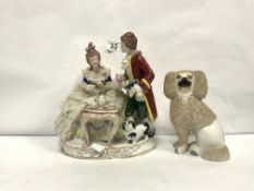 A CONTINENTAL PORCELAIN GROUP TEA TIME AND A STAFFORDSHIRE DOG, 24CMS