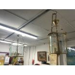TWO MODERN BRASS CYLINDRICAL HANGING LANTERN LIGHTS 70 X 40 CMS 50 X 24 CMS (SOME GLASS MISSING)