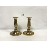 A PAIR OF OVAL BRASS CANDLESTICKS, 15CMS