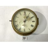 A CIRCULAR BRASS & STEEL SHIPS CLOCK WITH MILITARY CROWS FOOT CRUEDLY MARKED 18CMS DIAMETER