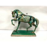 A GREEN/GOLD AND SILVER LACQUERED MOSAIC DESIGN FIGURE OF A PRANCING HORSE, 30CMS