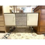 A 1960S MELAMINE AND CHROME HANDLE THREE DRAWER SIDEBOARD WITH PADDED DOORS, 40 X 12CMS