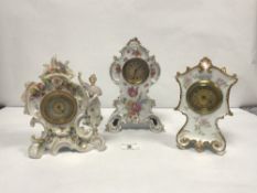 A PORCELAIN FLORAL ENCRUSTED CLOCK, 22CMS, AND TWO FLORAL DECORATED PORCELAIN CLOCKS