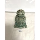 AN ORIENTAL GREEN GLAZED INCENSE BURNER WITH LOTUS LEAF DECORATION AND PIERCED CYLINDRICAL LID ON