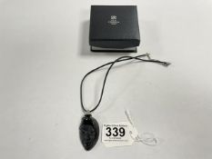 A MATS JONASSON BLACK GLASS PORTRAIT PENDANT ON CORD
