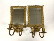 A PAIR OF EARLY 20TH CENTURY ORNATE BRASS MIRRORED TWO BRANCH WALL SCONCES, 22 X 34CMS