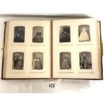 A VICTORIAN RED LEATHER CARTE DE VISITE PHOTOGRAPH ALBUM CONTAINING FAMILY PORTRAITS