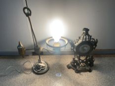 A LACEMAKERS CONVERTED LAMP AND ORNATE BRASS CLOCK WITH FIGURES IN ATTENDANCE
