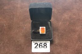 AN 18CT GOLD FIRE OPAL AND DIAMOND BORDERED DRESS RING SIZE O