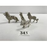 FOUR WHITE METAL FIGURES, THREE OF DOGS AND ONE LION