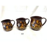 A GRADUATING SET OF THREE ROYAL DOULTON JUGS, ENTITLED MEMORIES