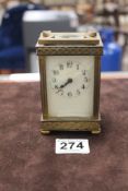 A LATE 19TH CENTURY BRASS CARRIAGE CLOCK WITH PORCELAIN DIAL WITH REEDED AND FRETWORK DECORATION,