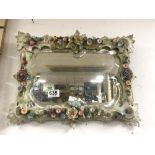 A LATE 19TH CENTURY PORCELAIN SHAPED FLORAL ENCRUSTED BEVELED WALL MIRROR, 40 X 34CMS