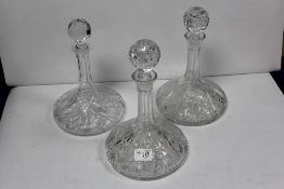 A PAIR OF HEAVY CUT GLASS SHIPS DECANTERS AND ANOTHER SHIPS DECANTER, 30CMS