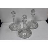 A PAIR OF HEAVY CUT GLASS SHIPS DECANTERS AND ANOTHER SHIPS DECANTER, 30CMS