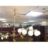 A 1970S TEN BRANCH ELECTROLIER WITH WHITE GLASS GLOBE SHADES