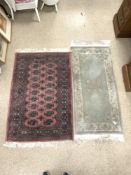 A BAKHARA RUG, 120 X 82CMS AND A CHINESE RUG, 130 X 60CMS