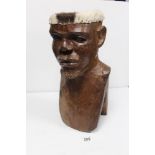 A 20TH CENTURY CARVED WOODEN TRIBAL BUST OF A MAN CONSTRUCTED AS A DRUM, 48CMS