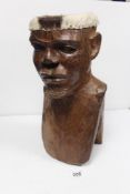 A 20TH CENTURY CARVED WOODEN TRIBAL BUST OF A MAN CONSTRUCTED AS A DRUM, 48CMS