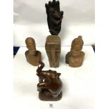 A CARVED LONG FACED TRIBAL BUST AND TWO OTHER CARVED WOODEN BUSTS, A FIGURE, AND AN ELEPHANT