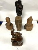 A CARVED LONG FACED TRIBAL BUST AND TWO OTHER CARVED WOODEN BUSTS, A FIGURE, AND AN ELEPHANT