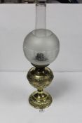 A VICTORIAN EMBOSSED BRASS BALUSTER SHAPED OIL LAMP, 60CMS