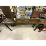 A LONG SLIM METAL BASED HALL TABLE WITH YEWOOD UNDER GLASS TOP