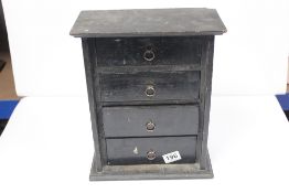 A MINIATURE PAINTED COLLECTORS CHEST OF DRAWERS CONTAINING NUMEROUS POCKET WATCH FACES AND MORE,
