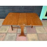 A MID-CENTURY TEAK DROP LEAF DINING TABLE