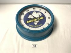 A VINTAGE STYLE MICHELIN TYRES CIRCULAR WALL CLOCK, 27CMS DIAMETER