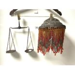 A METAL AND BEADED DROP HANGING LIGHT AND A SMALL SET OF BALANCE SCALES