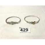 TWO HALLMARKED SILVER BANGLES, ONE SET IN BLUESTONE AND THE OTHER A YELLOW/ORANGE STONE, TOTAL