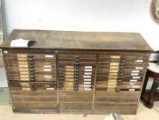 A LARGE FRENCH PRINTERS BANK OF 42 DRAWERS WITH SLOPING TOP, 196 X 48 X 120CMS