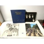 A BEATLES COLLECTION SET OF 33 RP RECORDS IN ORIGINAL CASE AND A BEATLES BOOK - A PRIVATE VIEW BY