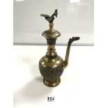AN EARLY 20TH ARABIAN ENGRAVED AND EMBOSSED BRONZE AND SILVERED EWER WINE JUG, WITH BIRD HANDLES AND