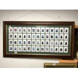 A FRAMED DECK OF CARDS OF PHOTOGRAPHS OF THE IRAQ CABINET STARTING WITH SADDAM HUSSAIN (ACE), 95 X