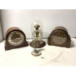 A HERMLE CLOCK UNDER GLASS DOME, A SWIZA JEWELLED DESK CLOCK, ANOTHER AND TWO OAK MANTEL CLOCKS